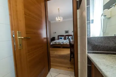 a door leading into a room with a bedroom at Guesthouse Bistra in Vrhnika