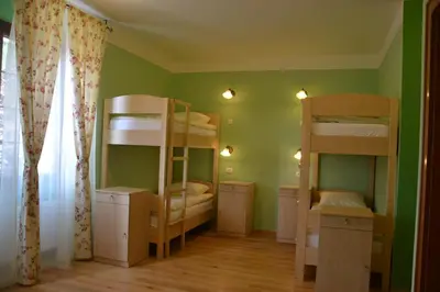 a room with bunk beds in a room with green walls at Guesthouse Bistra in Vrhnika