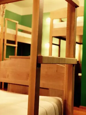 a room with two bunk beds and two chairs at Guesthouse Bistra in Vrhnika