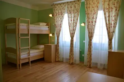 a room with two bunk beds and two windows at Guesthouse Bistra in Vrhnika