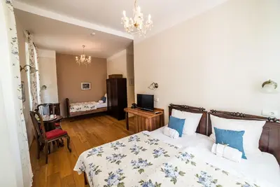 a bedroom with a bed and a living room at Guesthouse Bistra in Vrhnika