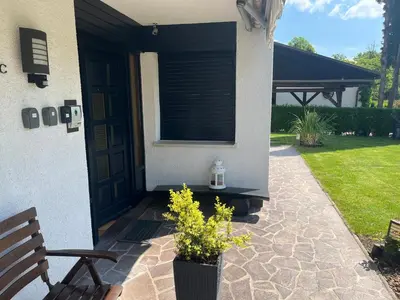 a porch of a house with a window and a bench at Sara`s Guesthouse Bled in Bled