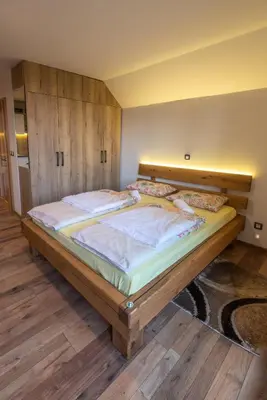 a bedroom with a large bed in a room at Vineyard Cottage Krivic in Trebelno