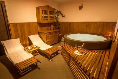 a bath room with two chairs and a tub at Vineyard Cottage Krivic in Trebelno