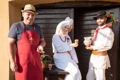 a group of three people dressed up in costumes at Vineyard Cottage Brodaric in Metlika