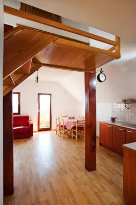 a living room with a red couch and a table at Vineyard Cottage Lustek in Novo Mesto