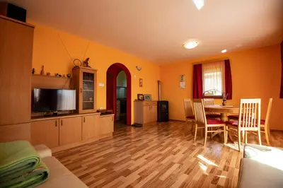 a living room with a table and a dining room at Vineyard Cottage Pod Piramido in Dobrnič
