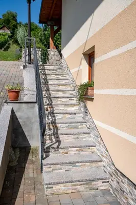 a set of stone stairs next to a building at Vineyard Cottage Pod Piramido in Dobrnič