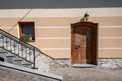 a wooden door on the side of a building at Vineyard Cottage Pod Piramido in Dobrnič
