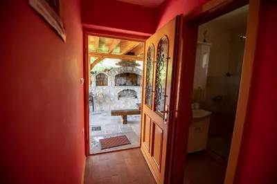 an open door to a room with a view of a bathroom at Vineyard Cottage Pod Piramido in Dobrnič