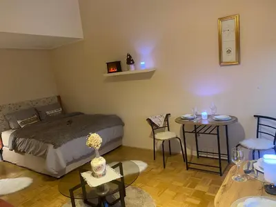 a bedroom with a bed and a table and chairs at Apartment La Vie in Maribor
