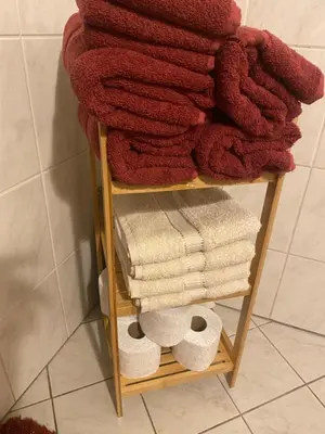 a towel rack with towels and a pile of towels at Apartment La Vie in Maribor
