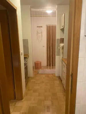 a hallway of a kitchen with a wooden floor at Apartment La Vie in Maribor