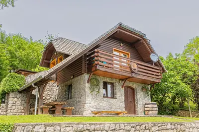 a small stone house with a wooden roof at Vineyard Cottage Rataj 1 in Novo Mesto