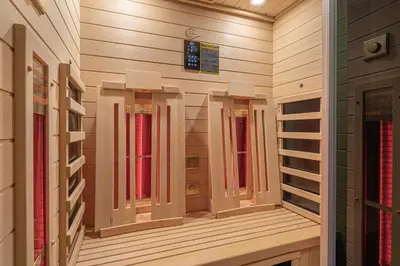 a walk in closet with wooden walls and windows at Vineyard Cottage Rataj 1 in Novo Mesto