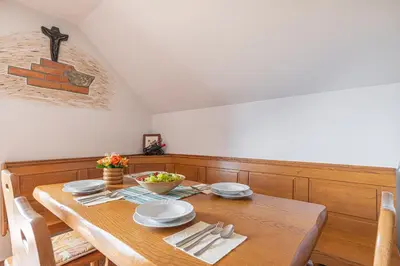 a dining room table with plates and utensils on it at Vineyard Cottage Rataj 1 in Novo Mesto