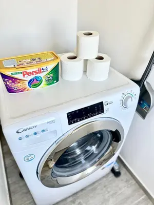 a washing machine with toilet paper on top of it at 2022 Central Apartment Maribor (Garden + Parking) in Maribor