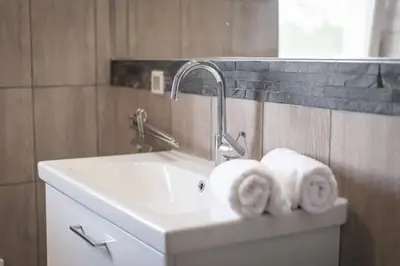 a bathroom sink with towels on top of it at 2022 Central Apartment Maribor (Garden + Parking) in Maribor