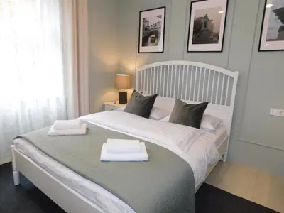 a bedroom with a bed with two towels on it at Cankar's cute apartment in Ljubljana