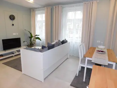 a living room with a couch and a table at Cankar's cute apartment in Ljubljana