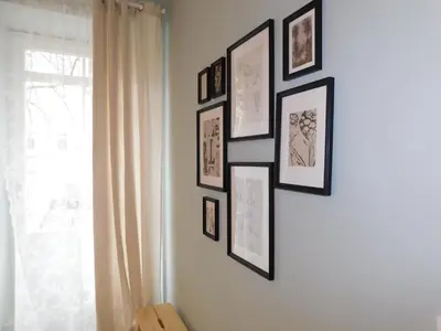 a group of framed pictures on a wall at Cankar's cute apartment in Ljubljana