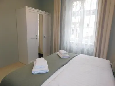 a bedroom with a bed with two towels on it at Cankar's cute apartment in Ljubljana