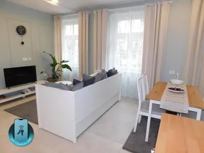 a living room with a couch and a table at Cankar's cute apartment in Ljubljana