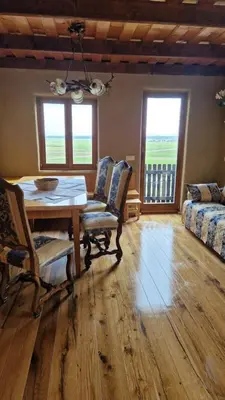 a dining room with a table and chairs and a couch at Holiday House Clavis in Dobrovnik