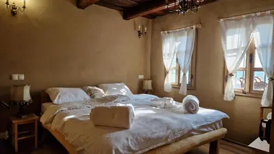 a bedroom with a large bed with towels on it at Holiday House Clavis in Dobrovnik