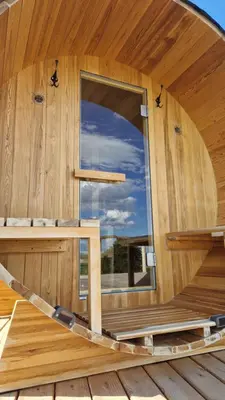 a wooden cabin with a large window in it at Holiday House Clavis in Dobrovnik
