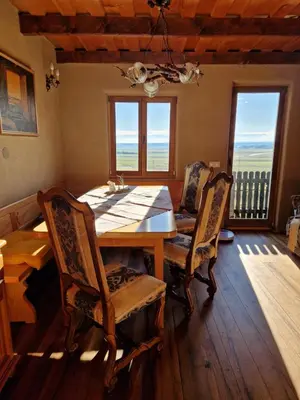 a dining room with a wooden table and chairs at Holiday House Clavis in Dobrovnik