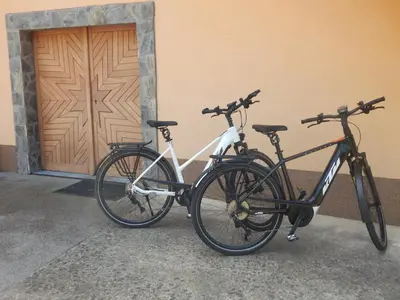 two bikes parked next to a building with a door at Vineyard Cottage Ucman in Otočec