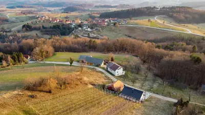 an aerial view of a farm in a field at Vineyard Cottage Tramte in Škocjan