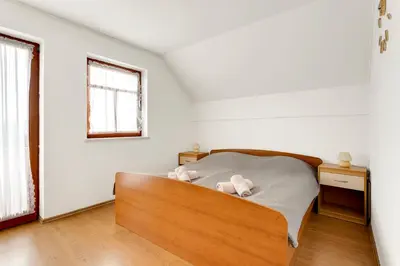 a bedroom with a bed with two teddy bears on it at Vineyard Cottage Tramte in Škocjan
