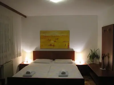 a bedroom with a bed and a painting on the wall at Guesthouse Zorko Gostilna Domen in Smarjeske Toplice