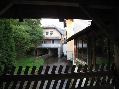 a view of a house from behind a fence at Guesthouse Zorko Gostilna Domen in Smarjeske Toplice