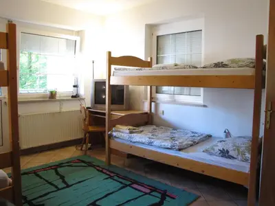 a room with two bunk beds and a desk at Guesthouse Zorko Gostilna Domen in Smarjeske Toplice