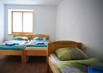 two bunk beds in a room with a window at Turistična kmetija Pri Požarju in Knežak
