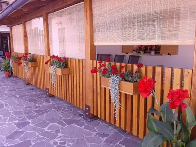 a row of stalls with red flowers in them at Turistična kmetija Pri Požarju in Knežak