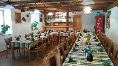 a large dining room with long tables and chairs at Turistična kmetija Pri Požarju in Knežak