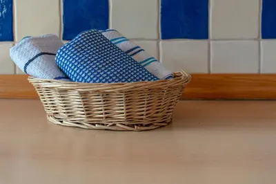 a wicker basket sitting on a kitchen floor at Apartments Maja by the river in Bohinj