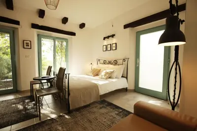 a bedroom with a bed and a table and chairs at Boutique Hotel Dvor in Dobrovo