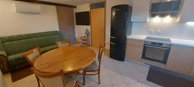 a kitchen and dining room with a wooden table at Apartments Lenardic in Bled