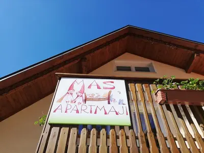 a sign on the side of a building at Apartments Mas in Dovje