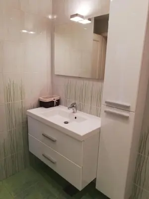 a bathroom with a white sink and a mirror at Apartments Mas in Dovje