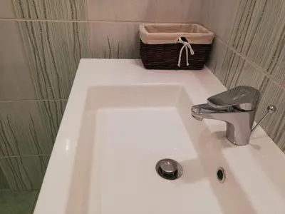 a white bath tub with a basket on top of it at Apartments Mas in Dovje