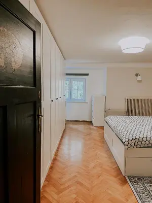 a bedroom with a bed and a wooden floor at Vila Del Linz in Ljubljana