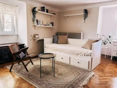 a bedroom with a white bed and a chair at Vila Del Linz in Ljubljana