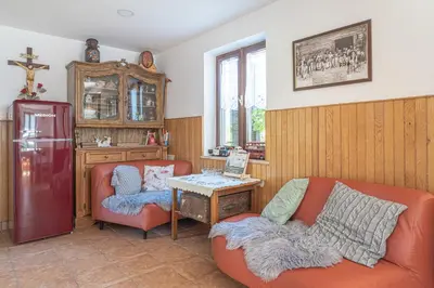 a living room with a couch and a table at Vineyard Cottage Vrbek in Roginska Gorca