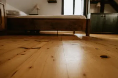 a room with a bed and a wooden floor at Vineyard Cottage Zdolsek in Šmarje pri Jelšah